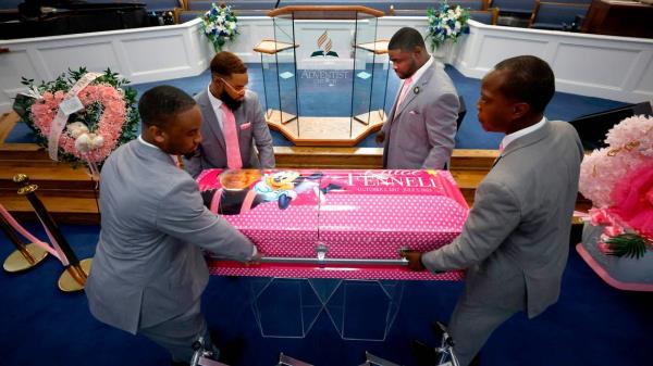 Clockwise from top left, Christopher Weaver, Curtis Peaks, Michael Kithcart and Kamal Simpson with Weaver & Peaks Funeral Care place the casket of five-year-old Khloe Fennell just below the pulpit at Immanuel Temple Church before her funeral in Durham, N.C., Friday, July 21, 2023. Fennell was killed by gunfire on July 5th.