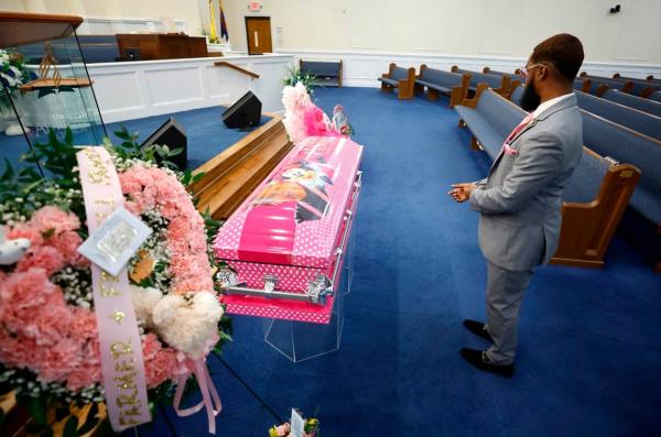 Christopher Weaver, an owner of Weaver & Peaks Funeral Care, checks on the floral arrangements before the funeral of five-year-old Khloe Fennell at Immanuel Temple Church in Durham, N.C., Friday, July 21, 2023. Fennell was killed by gunfire on July 5th.
