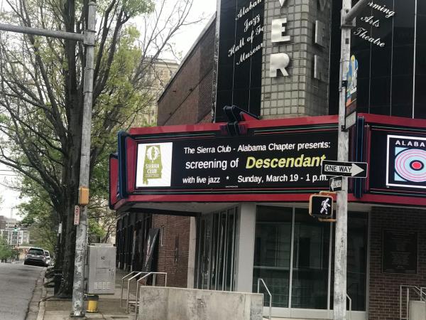 The marquee sign at the Carver Theatre advertises a screening of "Descendant."